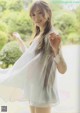 A woman in a white dress posing for a picture.