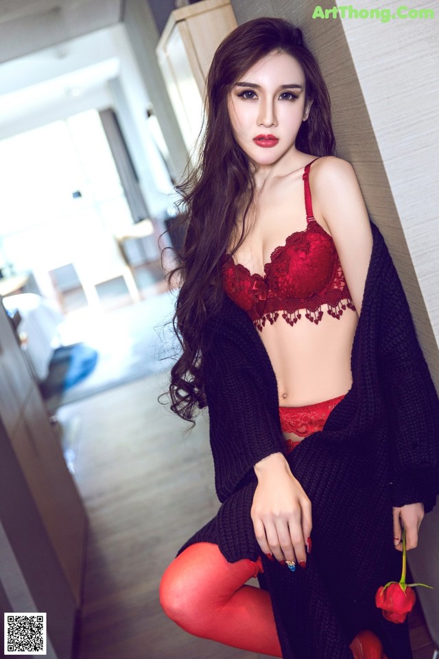 A woman in a red lingerie posing for a picture.